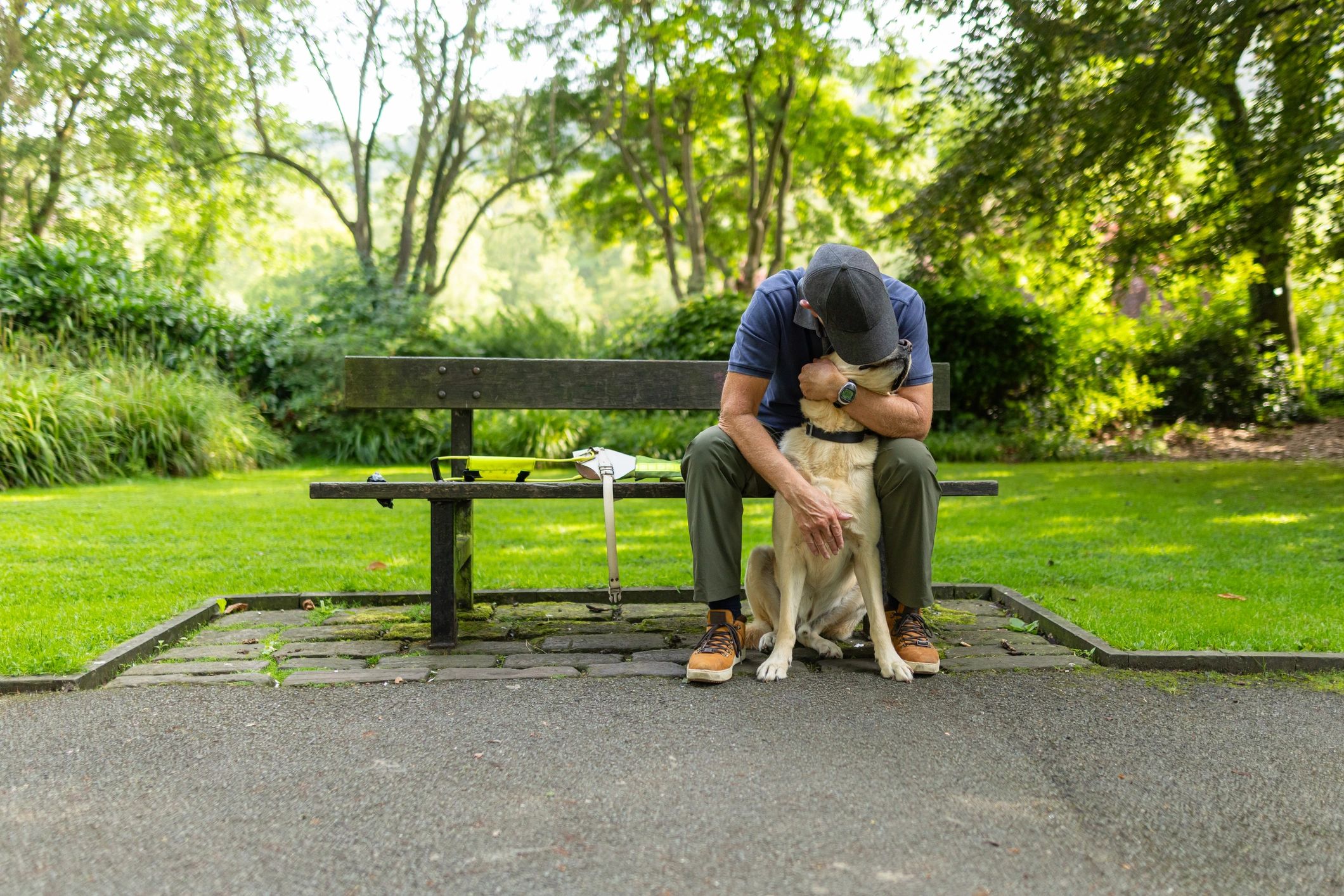 Pet owner sharing a warm moment with a dog in a park