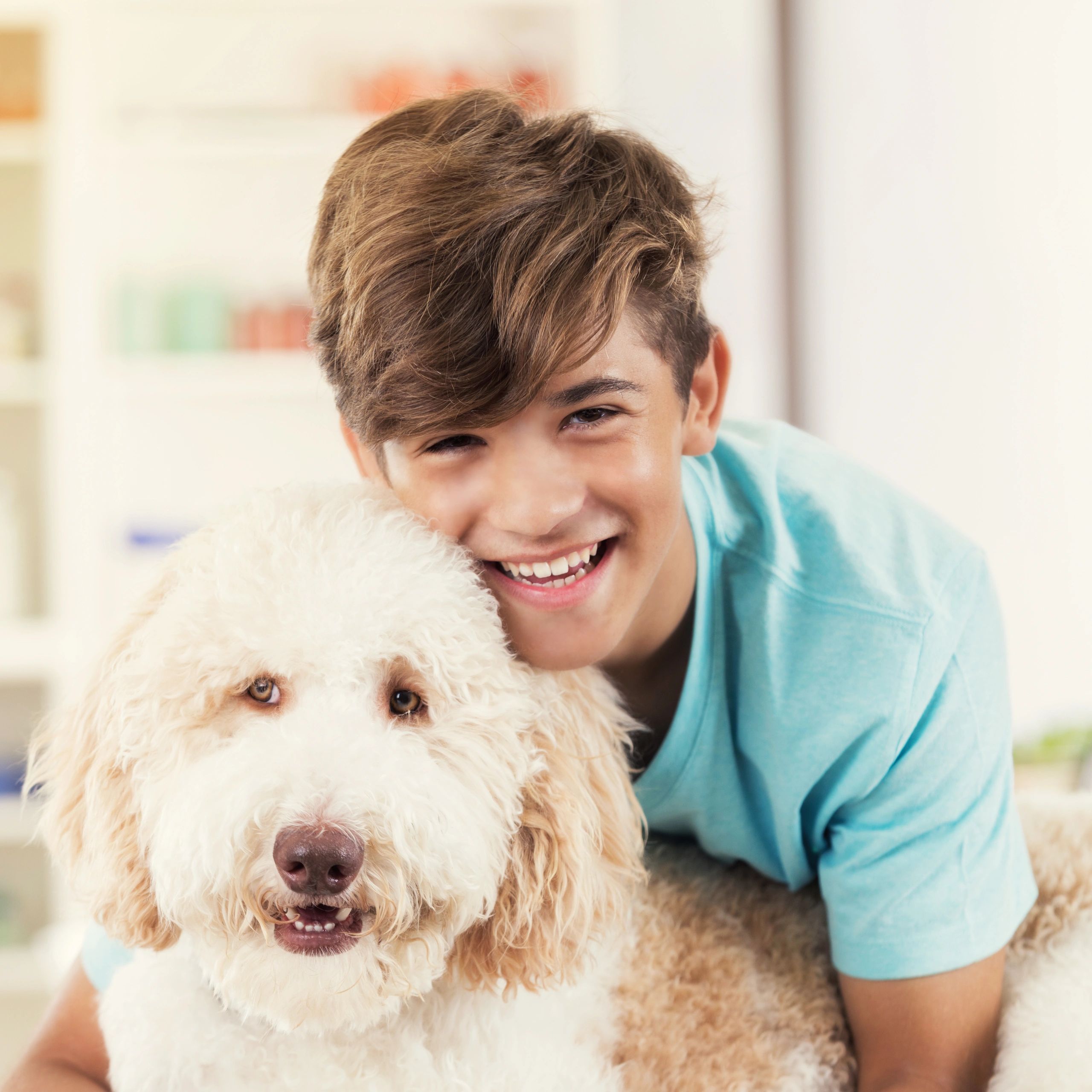 Teenage boy hugging his dog